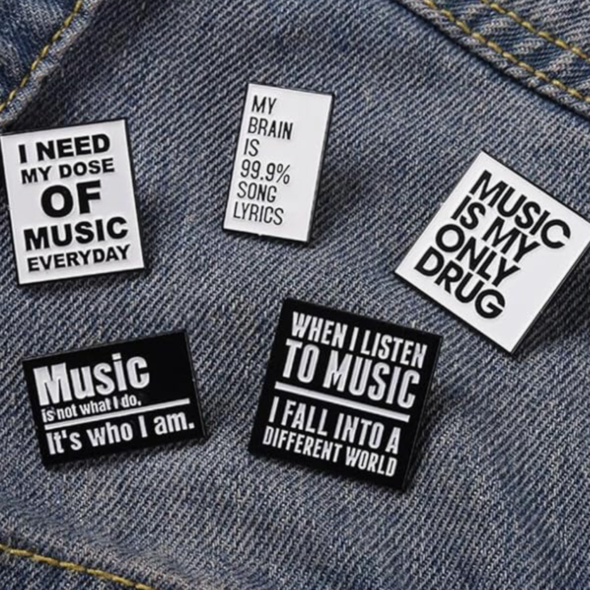 Music and art themed enamel pins featuring instruments, paint palettes and creative icons